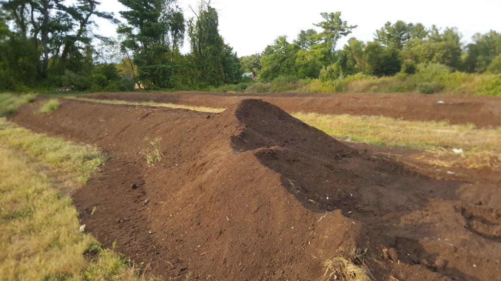 Soft, fluffy, leaf-based compost material ready for sale.